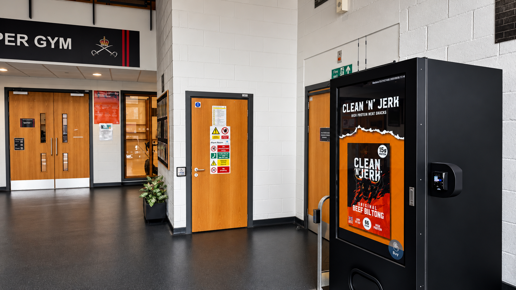 Interactive vending machine with contactless payment reader installed in a military gym entrance.
