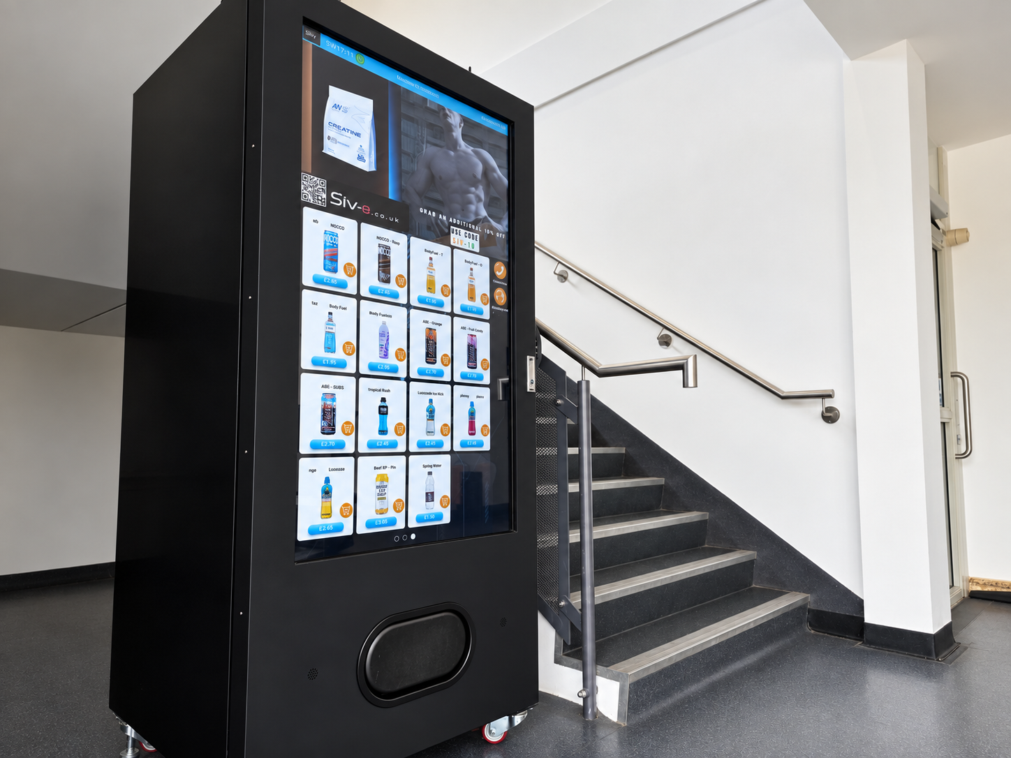 SIV vending machine installed beside an indoor staircase.